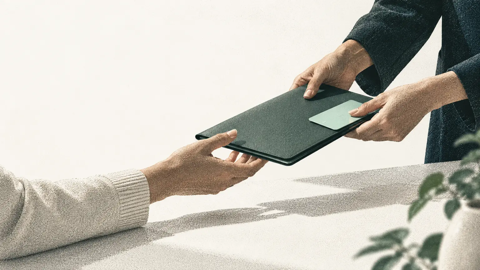 Two hands transferring a practical object that represents an operating handover.